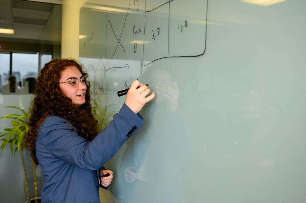 Woman drawing on whiteboard