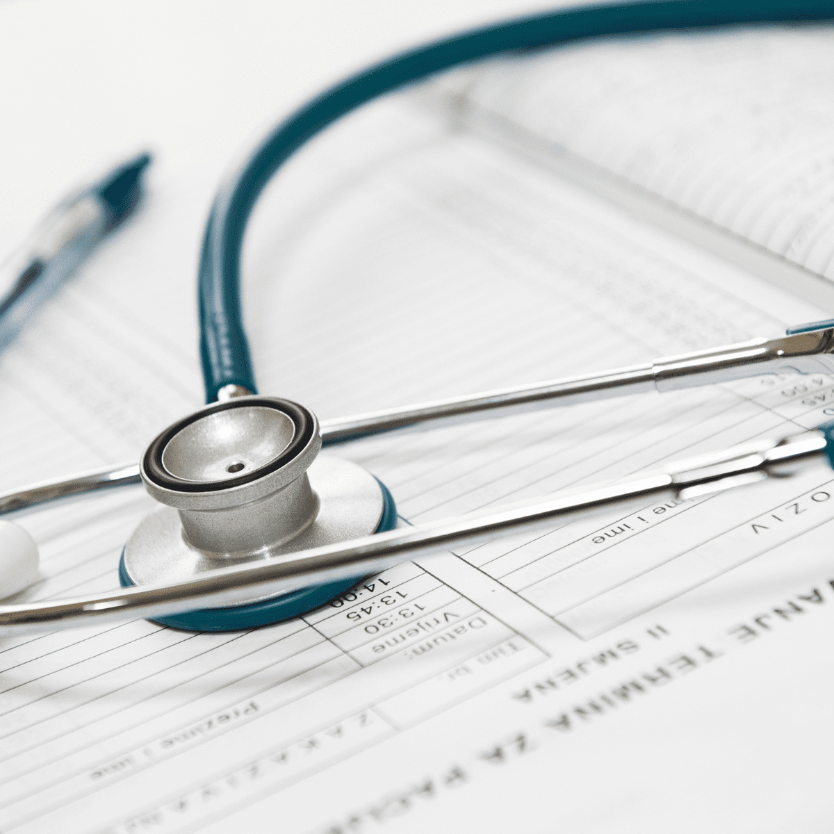 Photo of stethoscope and paper clip on paper